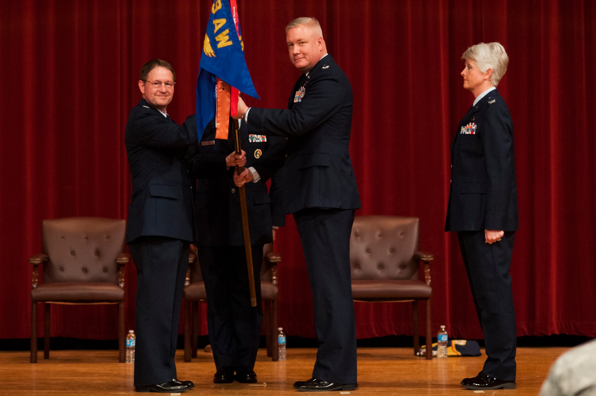 Col. Steve Eggensperger (from left), 189th Airlift Wing commander, passes the guidon to Col. Rob Ator, who relinquished command of the 189th Mission Support Group to Col. Tamhra Hutchins-Frye at Little Rock Air Force Base, Ark. on Jan. 11, 2014. (U.S. Air Force photo by Senior Airman Ian Caple)