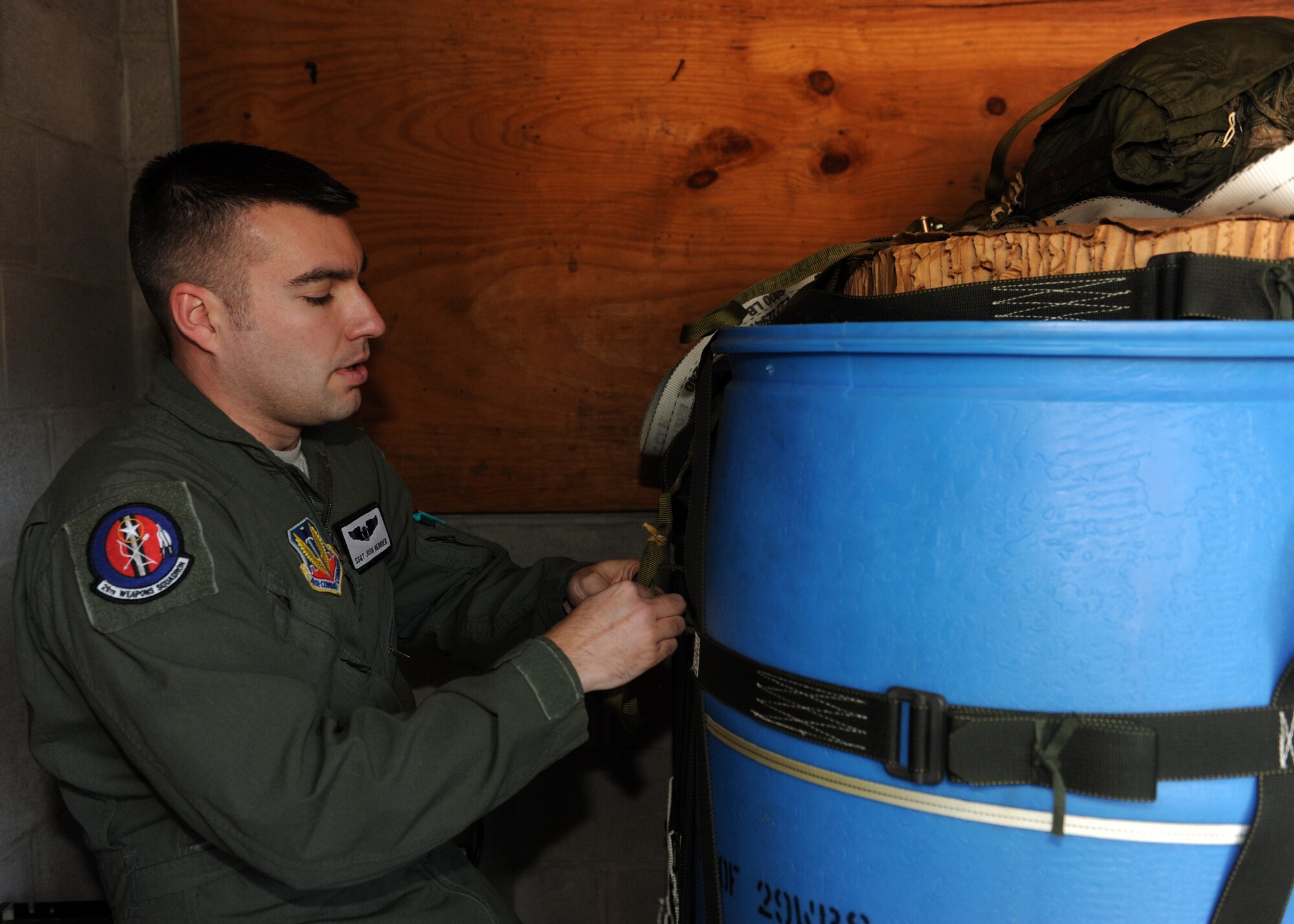 Staff Sgt. Joshua Herrier, a 29th Weapons Squadron instructor loadmaster, checks container webbing for proper rigging Jan. 21, 2014, at Little Rock Air Force Base, Ark. Herrier is a member of the Weapons Instructor Course cadre and is responsible for producing disciplined, knowledgeable and focused C-130 weapons officers. (U.S. Air Force photo by Airman 1st Class Scott Poe)