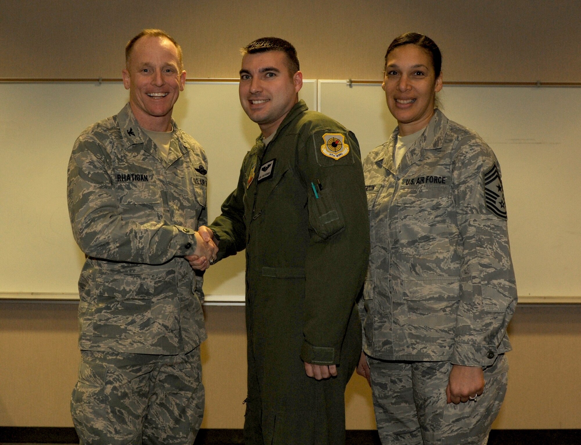 Col. Patrick Rhatigan, 19th Airlift Wing commander, along with Chief Master Sgt. Margarita Overton, 19th AW command chief, congratulate Staff Sgt. Joshua Herrier, a 29th Weapons Squadron instructor loadmaster, for his selection as Combat Airlifter of the Week Jan. 21, 2014, at Little Rock Air Force Base, Ark. Herrier, a Ravenna, Ohio native, is responsible for ensuring aircraft are flown within strict flight safety parameters according to the C-130J operating manuals. (U.S. Air Force photo by Airman 1st Class Scott Poe)