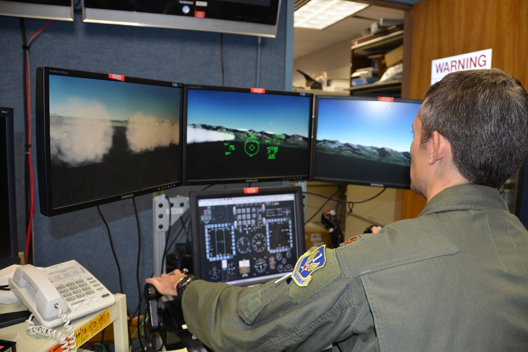 Maj. Christopher Fields, Deputy Director of AFNORTH Assessments, Lessons
Learned, and Exercises, flies a simulated fighter jet mission profile during
a recent training event at the AFNORTH Homeland Defense Distributed Training
Center. (Photo by Master Sgt Jerry Harlan)
