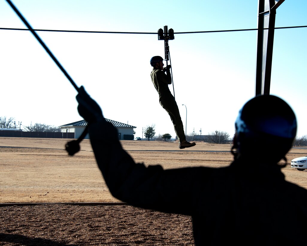 Aerospace Physiologists, 82nd Medical Squadron, instruct Euro-NATO Joint Jet Pilot Training students on the proper body position and parachute landing after ejecting from an aircraft on Dec. 12, 2013 at Sheppard Air Force Base, Texas. The training equipment is called a ‘Lateral Drift Line’. (U.S. Air Force photo by Frank Carter/Released)