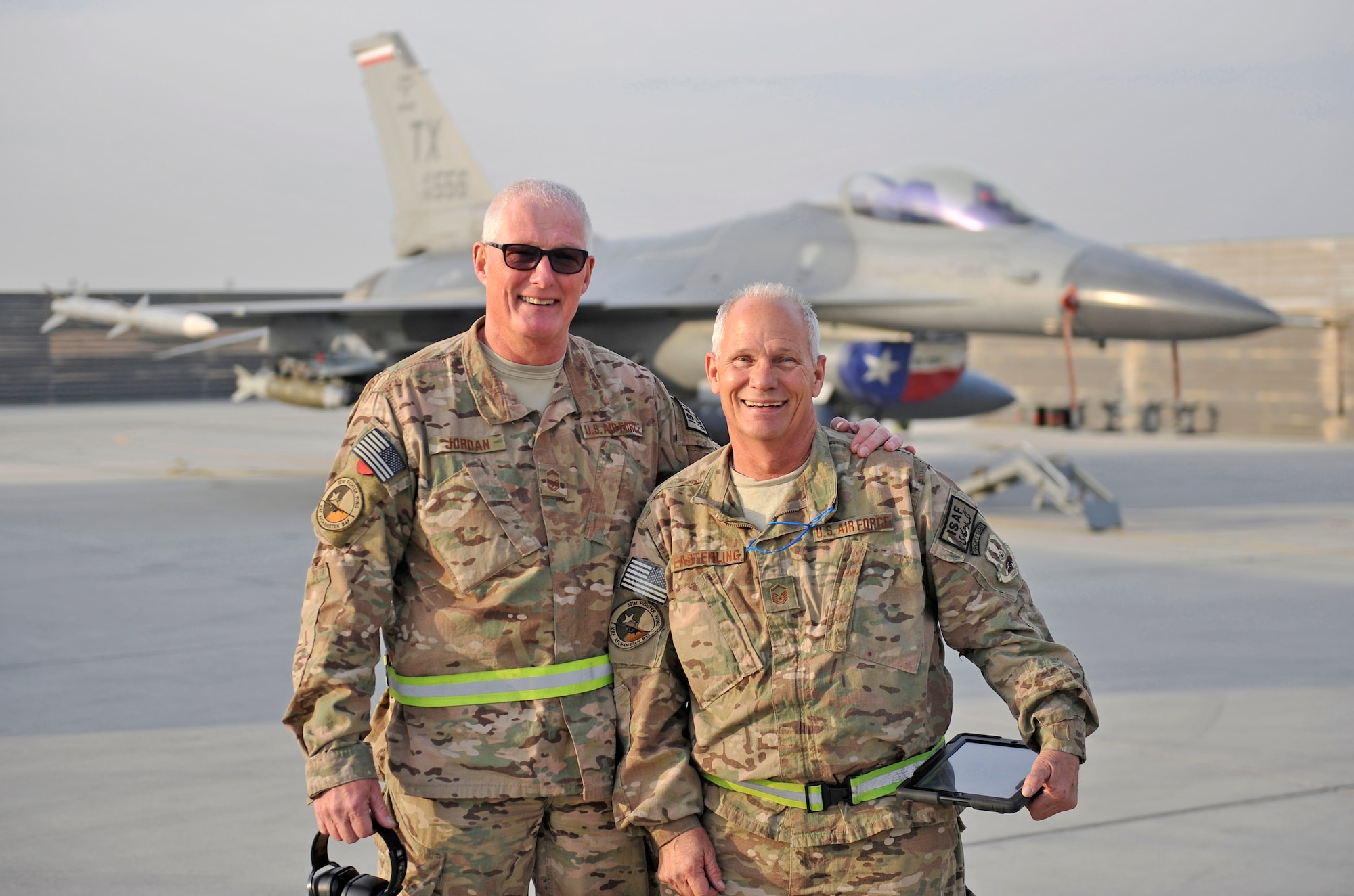 U.S. Air Force Senior Master Sgt. Paul Jordan and Master Sgt. Doyle Easterling stand together in front of their F-16 Fighting Falcon after a successful engine test run at Bagram Airfield, Afghanistan, Jan. 20, 2014. Both are deployed out of Carswell Joint Reserve Base in Fort Worth, Texas to Bagram, and will be retiring this year after a combined 78 years of military service. (U.S. Air Force photo by Senior Master Sgt. Gary J. Rihn/Released)