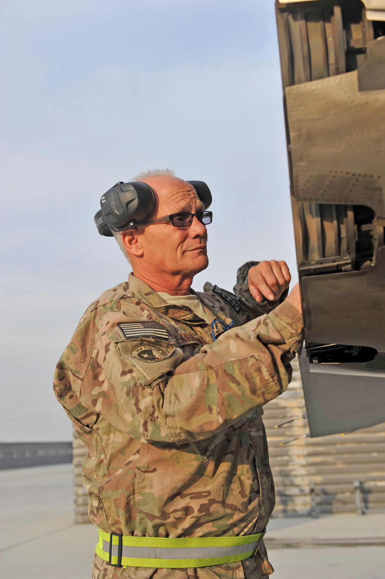 U.S. Air Force Master Sgt. Doyle Easterling glances inside an F-16 shortly after a test run at Bagram Airfield, Afghanistan, Jan. 20, 2014. Easterling is deployed out of Carswell Joint Reserve Base in Fort Worth, Texas to Bagram, and will be retiring this year after 36 years of military service. (U.S. Air Force photo by Senior Master Sgt. Gary J. Rihn/Released)