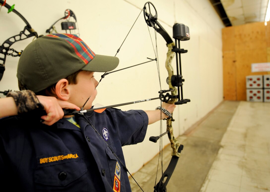 John Barrett, Boy Scouts of America Pack 60 webelos, takes aim at a target during the grand opening of the new Doolittle Archery Range at Ellsworth Air Force Base, S.D., Jan. 15, 2014. Barrett volunteered his time to help construct the range that features enclosed, well lit and clean shooting lanes. (U.S. Air Force photo by Senior Airman Anania Tekurio/Released)