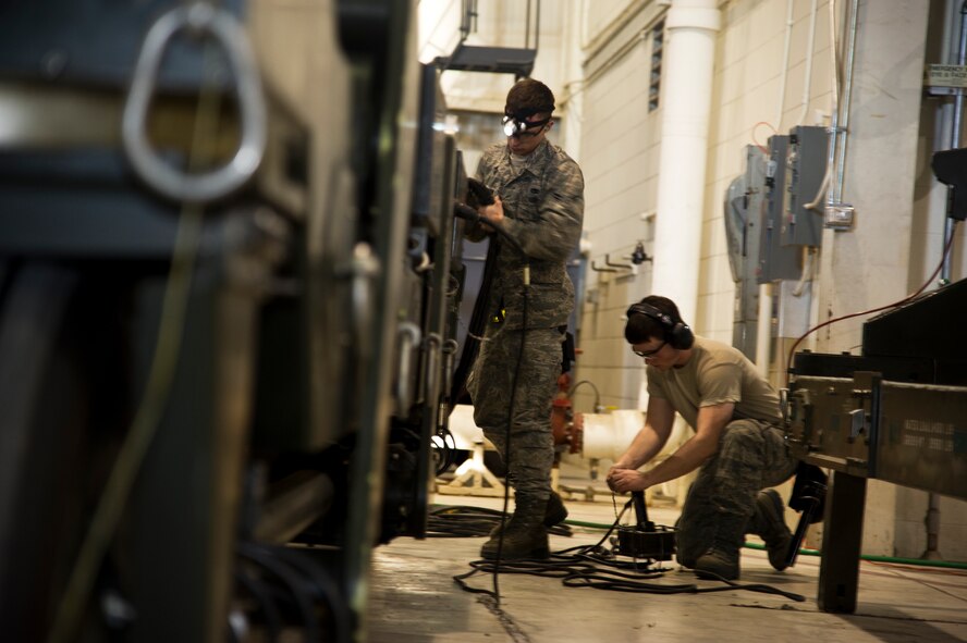 Airman 1st Class Alan Johnson and John Thompson, 5th Aircraft Maintenance Squadron weapons load crew members prepare a loading trailer at Minot Air Force Base, N.D., Jan. 14, 2013. As part of Air Force Global Strike Command, load crews work endlessly to preserve our nation’s security by providing combat-ready forces for nuclear deterrence and global strike operations. (U.S. Air Force photo/Senior Airman Brittany Y. Auld)