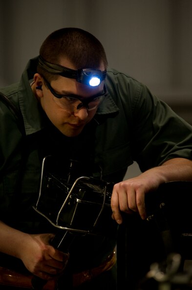 Senior Airman Garrett Reinarz, 5th Aircraft Maintenance Squadron weapons load crew member loads an AGM 86B air-launched cruise trainer missile in a B-52H Stratofortress at Minot Air Force Base, N.D., Jan. 14, 2013. Each load crew consists of four Airmen who are evaluated every month on how well they load various types of weapons. (U.S. Air Force photo/Senior Airman Brittany Y. Auld)