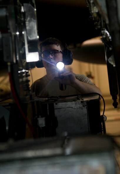 Airman 1st Class Alan Johnson, 5th Aircraft Maintenance Squadron weapons load crew member, prepares to load an AGM 86B air-launched cruise trainer missile in a B-52H Stratofortress at Minot Air Force Base, N.D., Jan. 14, 2013. Each load crew consists of four Airmen who are evaluated every month on how well they load various types of weapons. (U.S. Air Force photo/Senior Airman Brittany Y. Auld)
