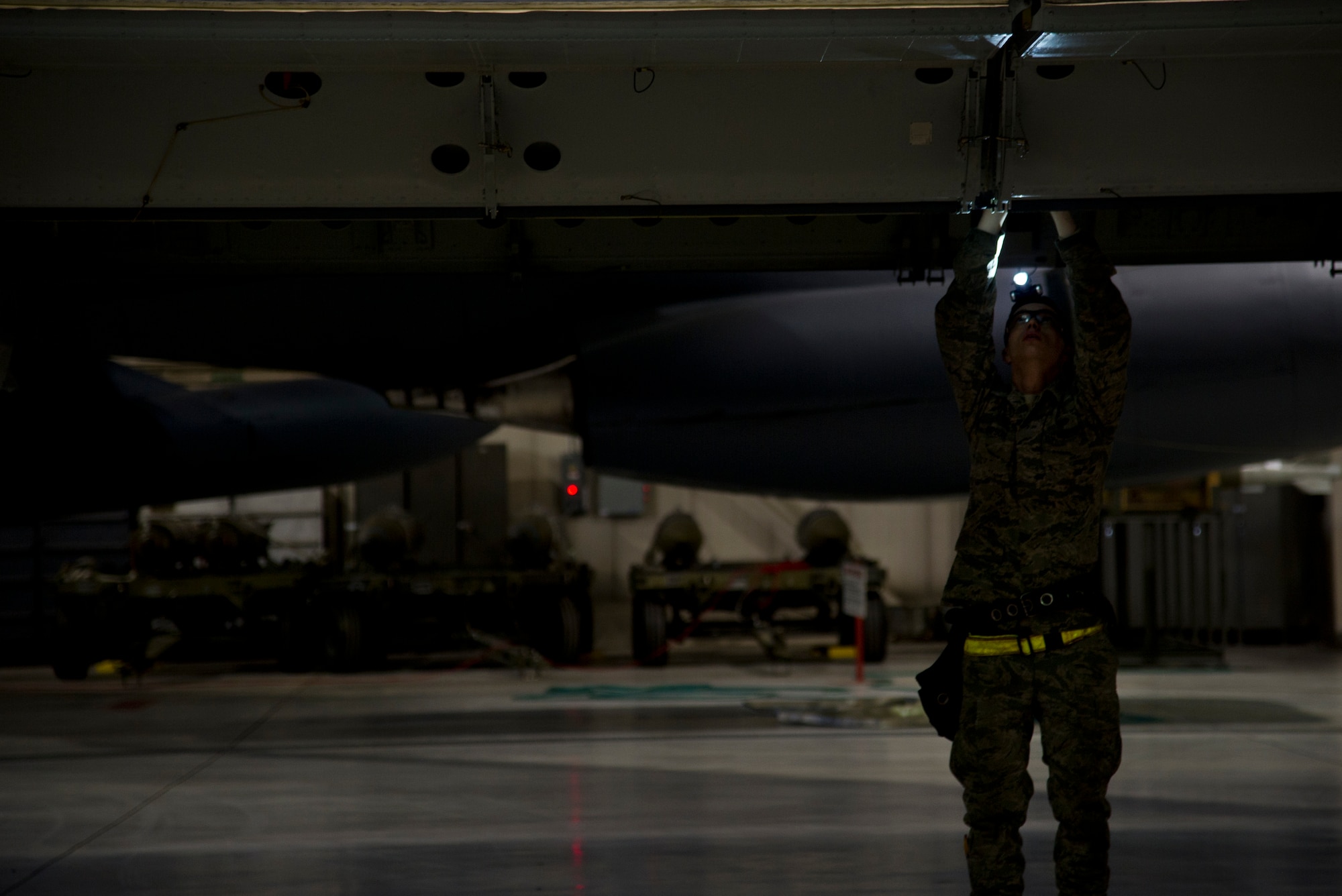 Airman 1st Class John Thompson, 5th Aircraft Maintenance Squadron weapons load crew member, prepares to load an AGM 86B air-launched cruise trainer missile in a B-52H Stratofortress at Minot Air Force Base, N.D., Jan. 14, 2013. As part of Air Force Global Strike Command, load crews work endlessly to preserve our nation’s security by providing combat-ready forces for nuclear deterrence and global strike operations. (U.S. Air Force photo/Senior Airman Brittany Y. Auld)
