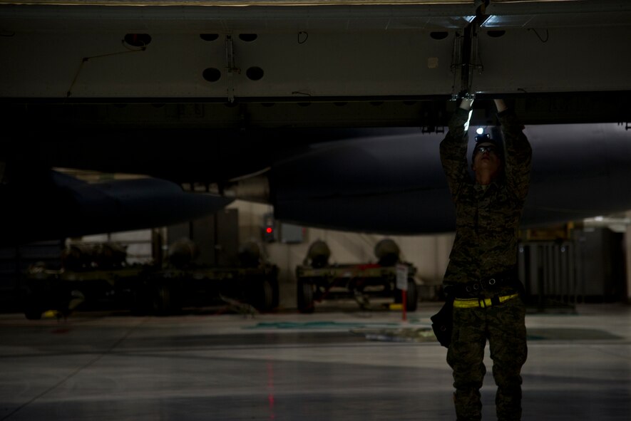 Airman 1st Class John Thompson, 5th Aircraft Maintenance Squadron weapons load crew member, prepares to load an AGM 86B air-launched cruise trainer missile in a B-52H Stratofortress at Minot Air Force Base, N.D., Jan. 14, 2013. As part of Air Force Global Strike Command, load crews work endlessly to preserve our nation’s security by providing combat-ready forces for nuclear deterrence and global strike operations. (U.S. Air Force photo/Senior Airman Brittany Y. Auld)