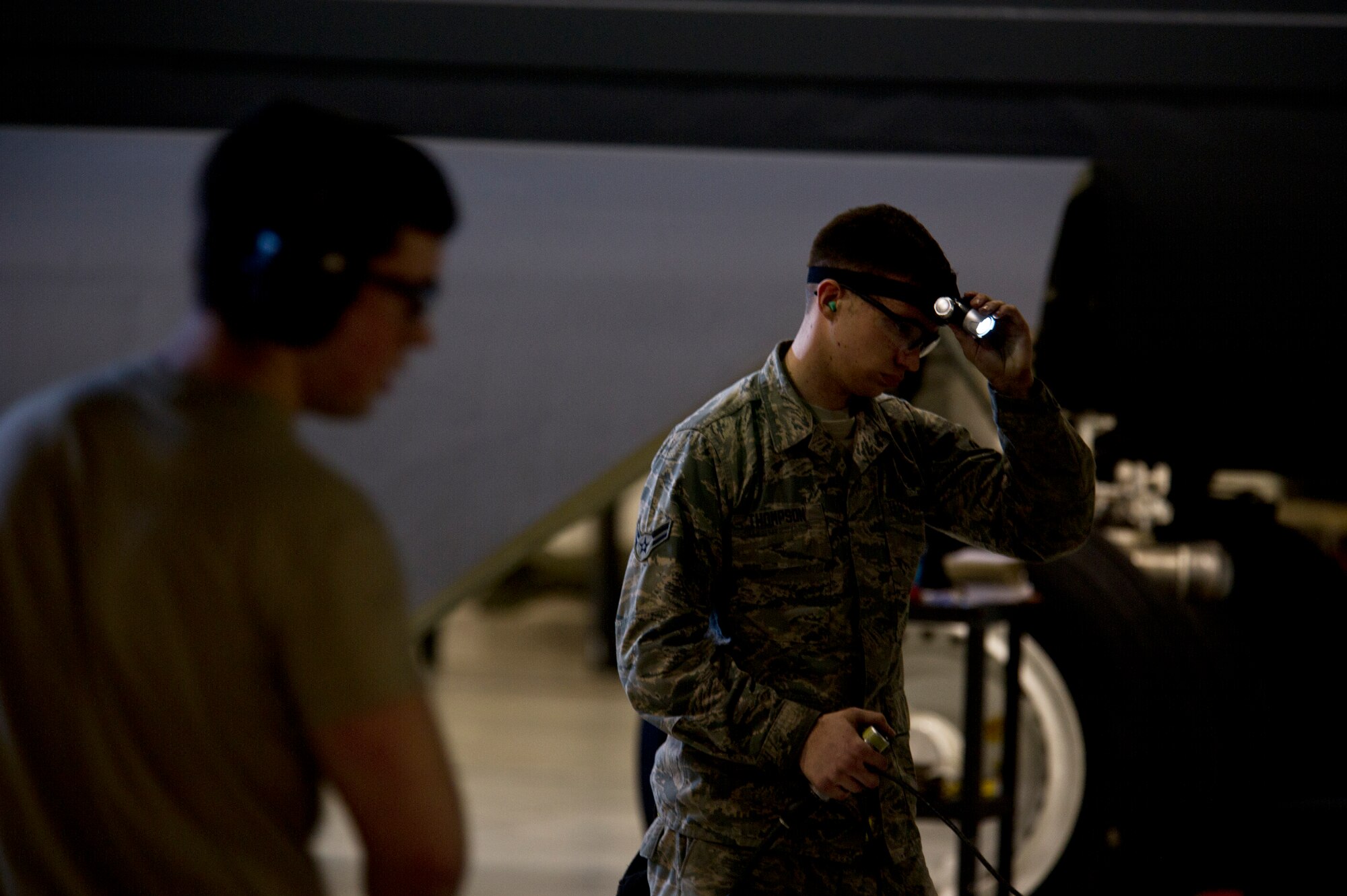 Weapons load crew members from the 5th Aircraft Maintenance Squadron lift the bomb bay doors of a B-52H Stratofortress at Minot Air Force Base, N.D., Jan. 14, 2013. Each load crew consists of four Airmen who are evaluated every month on how well they load various types of weapons. (U.S. Air Force photo/Senior Airman Brittany Y. Auld)