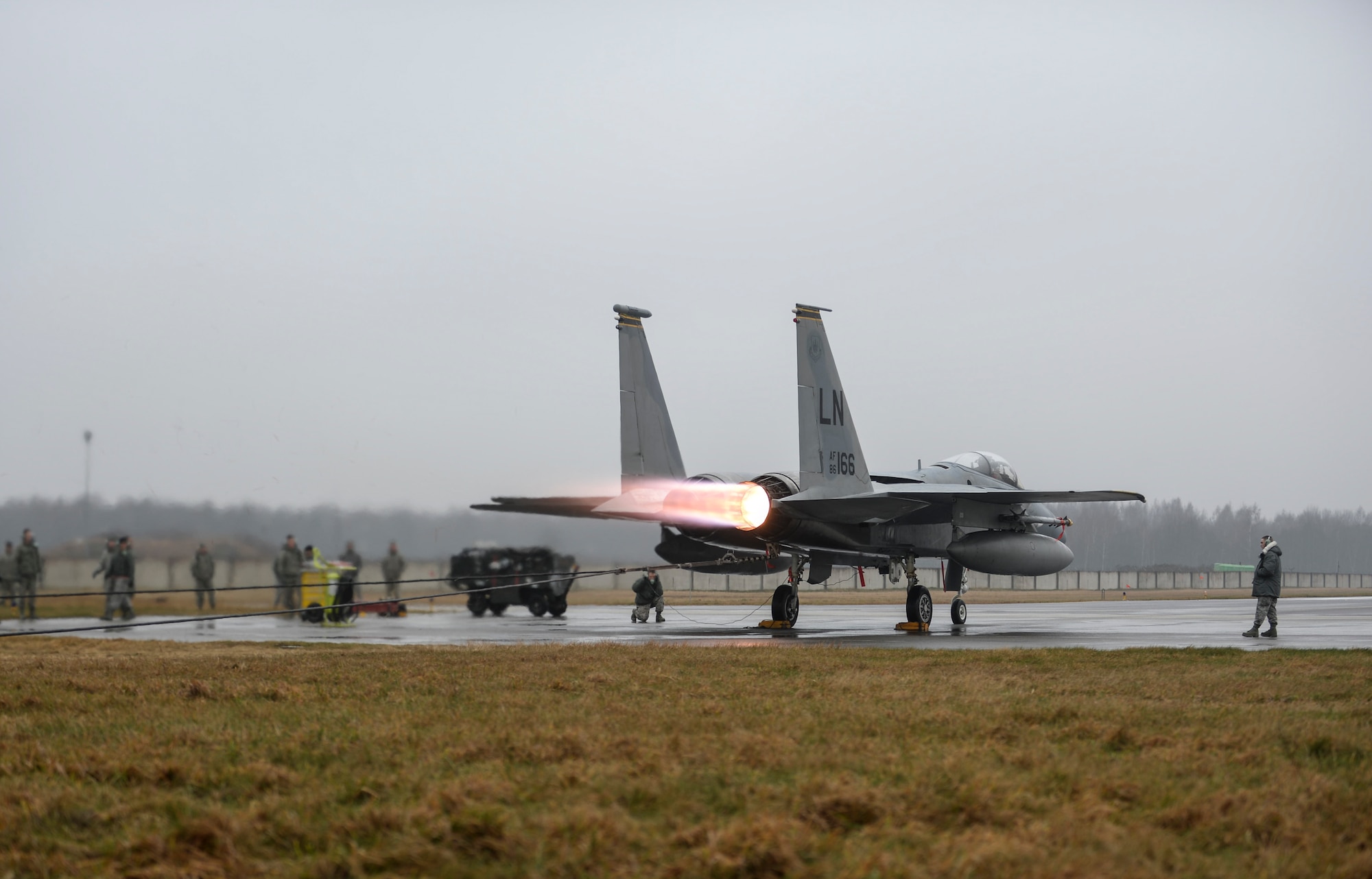 Maintainers perform an engine check on an F-15C Eagle at the flightline on Siauliai Air Base, Lithuania, Jan. 4, 2014. During the Baltic Air Policing mission, the 48th AEG installed an expeditionary trim pad for anchoring the F-15C’s during engine checks. (U.S. Air Force photo by Airman 1st Nigel Sandridge/Released)