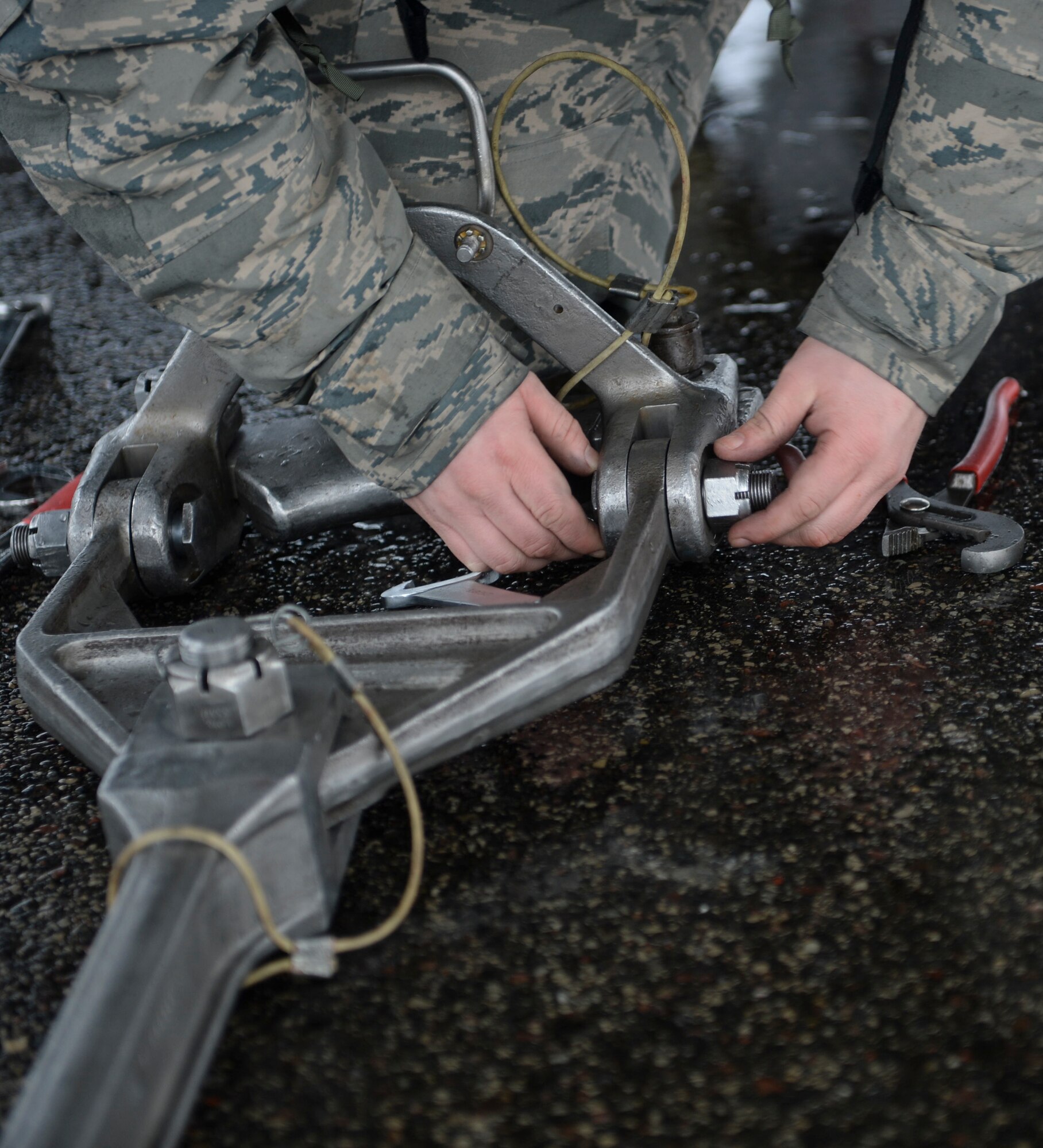 An anchoring device is attached to an F-15 Eagle before an engine test on the flightline on Siauliai Air Base, Lithuania, Jan. 4, 2014. During the Baltic Air Policing mission, the 48th AEG installed an expeditionary trim pad to conduct engine checks. (U.S. Air Force photo by Airman 1st Nigel Sandridge/Released)