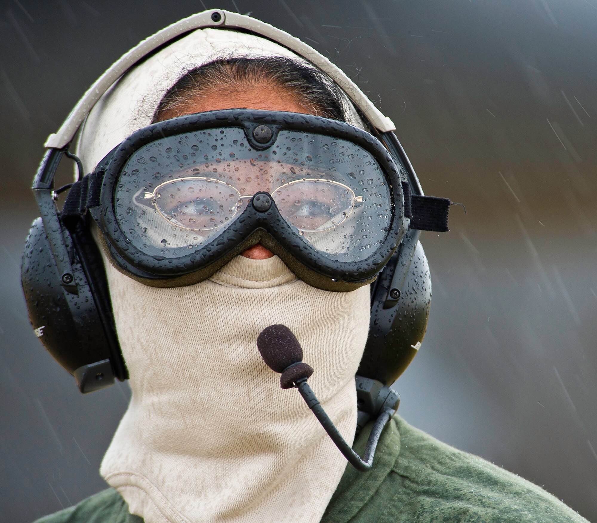 Capt. Tracy Tucker, a flight nurse with the 433rd Aeromedical Evacuation Squadron, Joint Base San Antonio-Lackland, Texas, works in the rain as a safety spotter during Exercise Global Medic 2013 at Fort McCoy, Wis. Global Medic is an annual joint field training exercise designed to replicate all aspects of theater combat medical support. (Tech. Sgt. Efren Lopez)