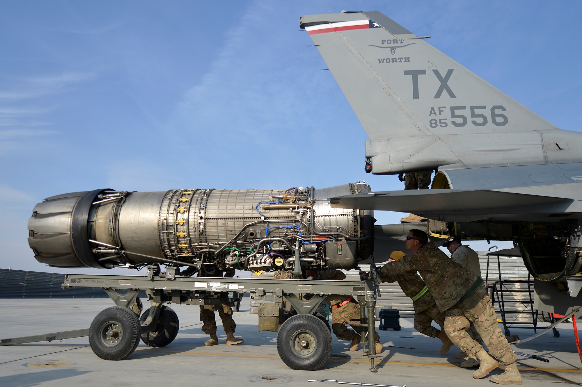 U.S. Air Force Airmen assigned to the 455th Expeditionary Aircraft Maintenance Squadron work to remove the engine from an F-16 Fighting Falcon at Bagram Airfield, Afghanistan, Jan. 22, 2014. The engine was scheduled for removal due to a bad hydraulic line. (U.S. Air Force photo by Senior Airman Kayla Newman/Released)