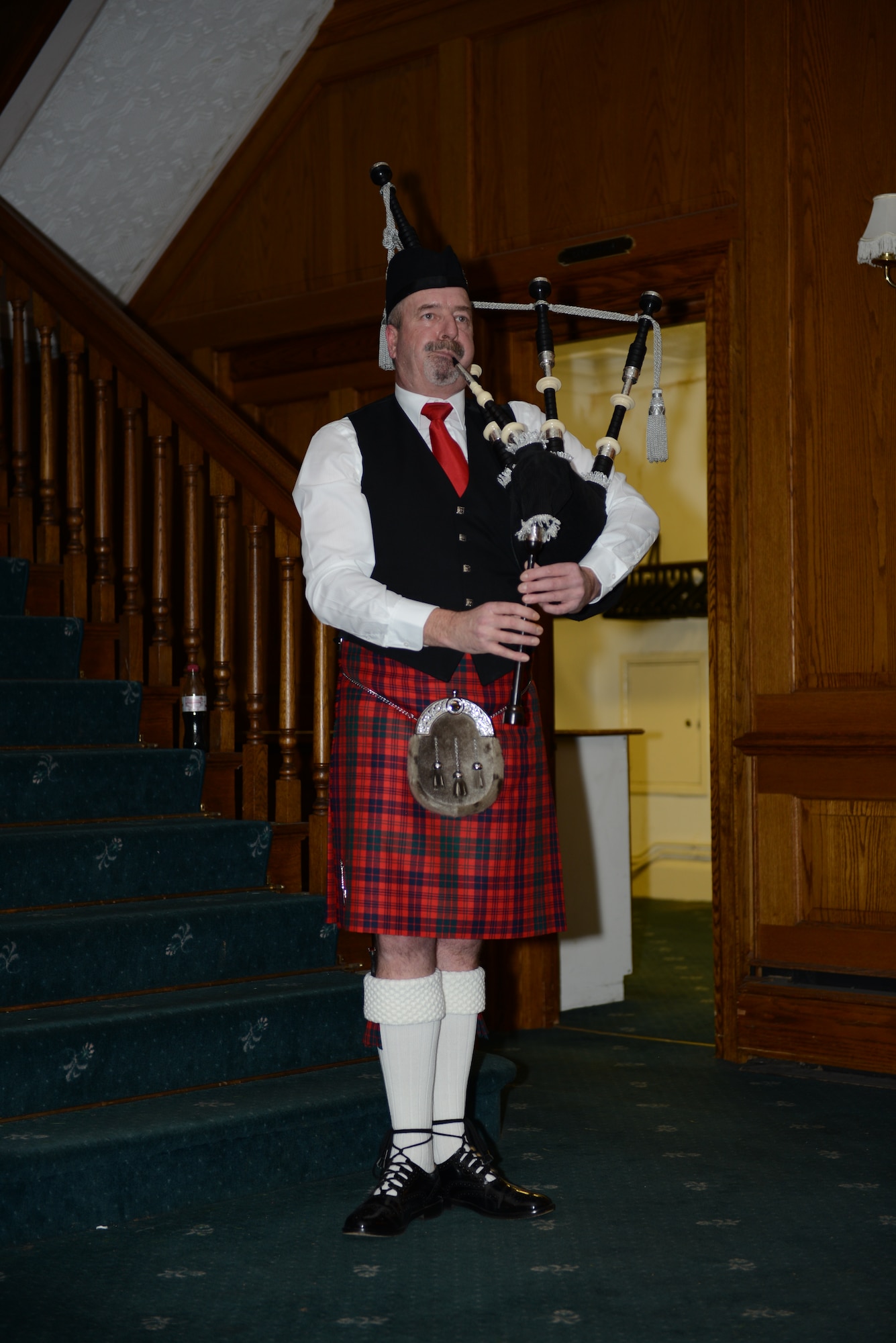 A traditional Scottish bagpiper plays at the British-American Committee Burns Night supper Jan. 18, 2014, in Middleton Hall on RAF Mildenhall, England. Those attending wear traditional Scottish dress to pay homage to Robert Burns. (U.S. Air Force photo by Airman 1st Class Preston Webb/Released)