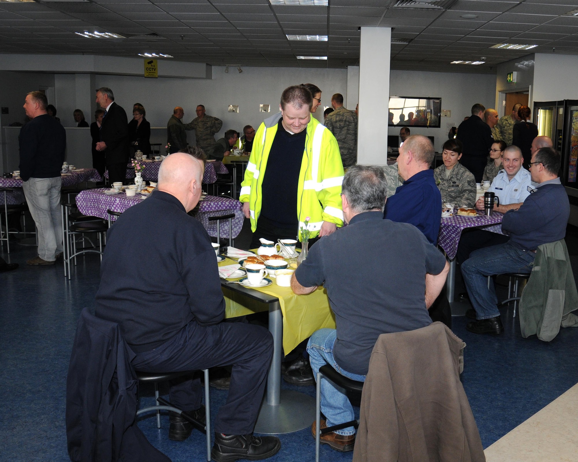 Members of the Ministry of Defence and the U.S. Air Force’s Air Mobility Command military personnel come together to celebrate Colin Grubb receiving the Imperial Service Medal Jan. 21, 2014, on RAF Mildenhall, England. Grubb worked at the 727th Air Mobility Squadron on RAF Mildenhall for 39 years with an impeccable record. The Imperial Service Medal recognizes long and faithful service in the Civil Service by an individual in an eligible grade on the retirement, resignation or redundancy. The individual must have at least 25 years of meritorious service. (U.S. Air Force photo by Gina Randall/Released) 
