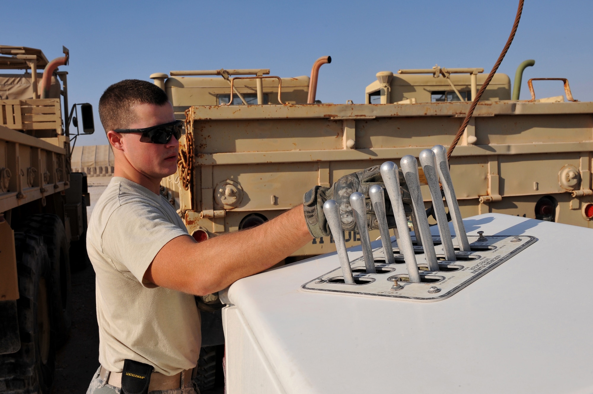 SrA Elisha Bryant prepares a U.S. Army M939 5-Ton vehicle for towing to a collection point at Al Udeid Air Base, Qatar, Jan. 17, 2014.The 379th Expeditionary Logistics Readiness Squadron was tasked to move 51 vehicles and miscellaneous pieces of equipment from the former 11th Air Defense Artillery Brigade, 1st Battalion, 43rd Air Defense Artillery Regiment site, to a collection point for further distribution. All vehicles were inoperable and had to be towed or loaded onto a flatbed trailer for movement. This was the final push in the complete movement of the 1-43rd ADA from their old site to their new location. The move took three days to complete. Bryant is deployed from Seymour Johnson Air Force Base and is a Goldsboro, N.C., native. (U.S. Air Force photo by Master Sgt. David Miller)