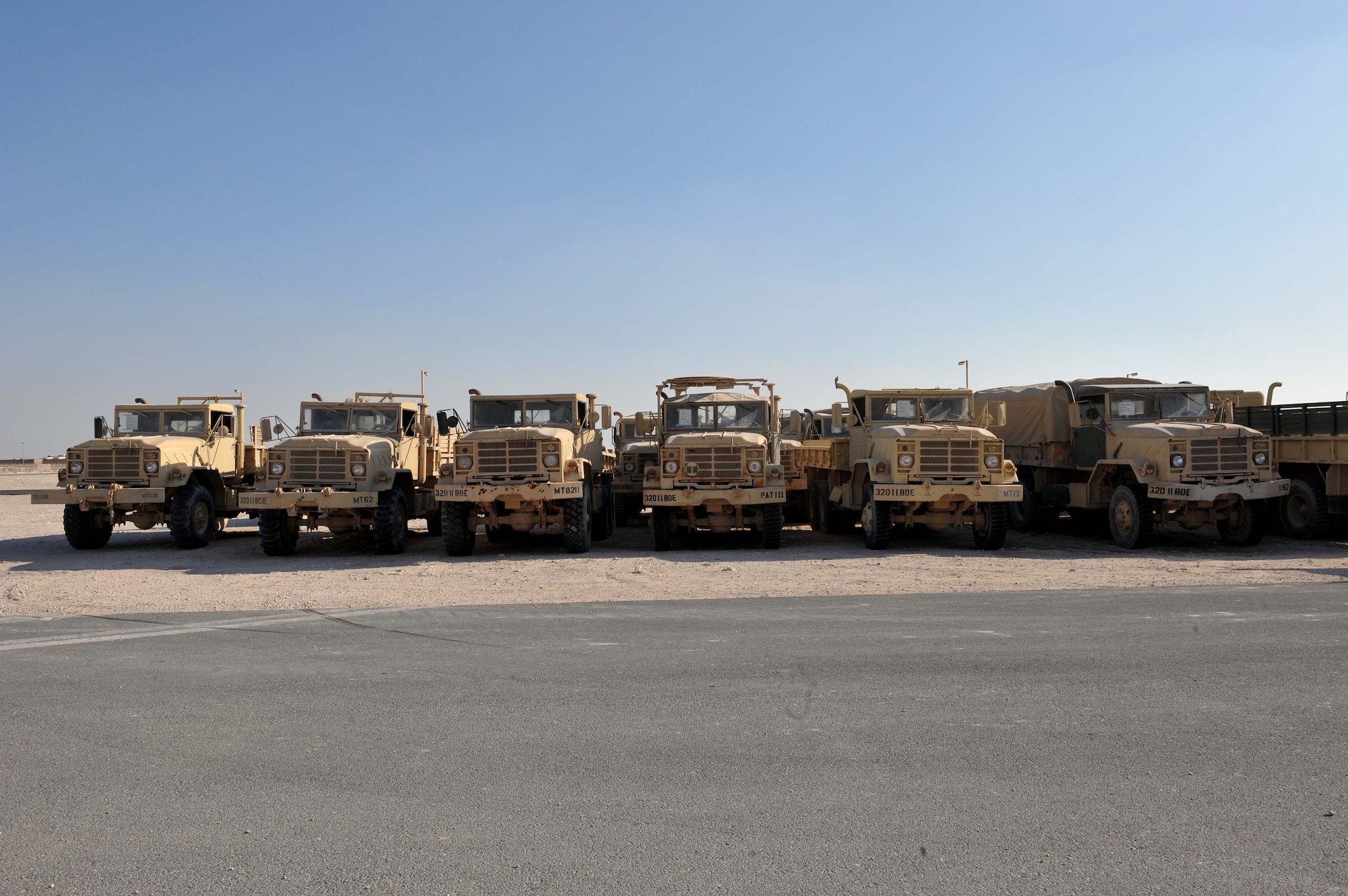 Recently moved U.S. Army M939 5-Ton vehicles are lined up at a collection point at Al Udeid Air Base, Qatar, Jan. 17, 2014. The 379th Expeditionary Logistics Readiness Squadron was tasked to move 51 vehicles and other miscellaneous pieces of equipment from the former 11th Air Defense Artillery Brigade, 1st Battalion, 43rd Air Defense Artillery Regiment site, to a collection point for further distribution. All vehicles were inoperable and had to be towed or loaded onto a flatbed trailer for movement. This was the final push in the complete movement of the 1-43rd ADA from their old site to their new location. Other items included in the move were CONNEX's, generators, tents, barriers, lightalls and other equipment. The move took three days to complete. (U.S. Air Force photo by Master Sgt. David Miller)