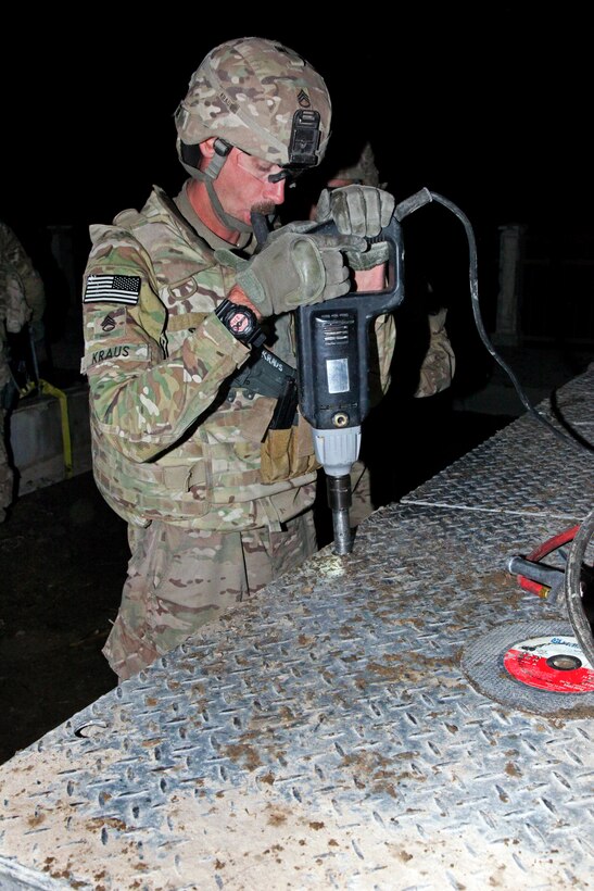 U.S. Army Staff Sgt. Steven Kraus helps dismantle an over bridge in the Gereshk district of Helmand province, Afghanistan, Jan. 16, 2014. Kraus is assigned to the Missouri National Guard's 1438th Multi-Role Bridge Company.