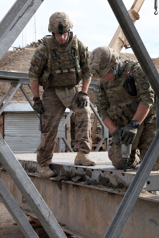 U.S. Army Sgts. Jonathan Guy, left, and Joshua Mancomber dismantle an over bridge in the Gereshk district of Helmand province, Afghanistan, Jan. 16, 2014. Guy and Mancomber are assigned to the Missouri National Guard's 1438th Multi-Role Bridge Company.
