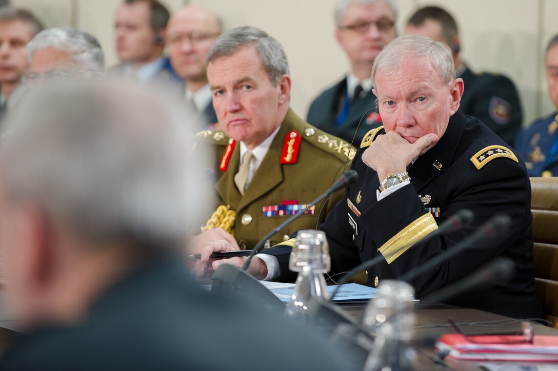 U.S. Army Gen. Martin E. Dempsey, right, chairman of the Joint Chiefs of Staff, and British Army Gen. Nicholas Houghton, chief of Britain’s defense forces, listen during the 170th NATO Chiefs of Defense meeting at NATO headquarters in Brussels, Jan. 22, 2014.