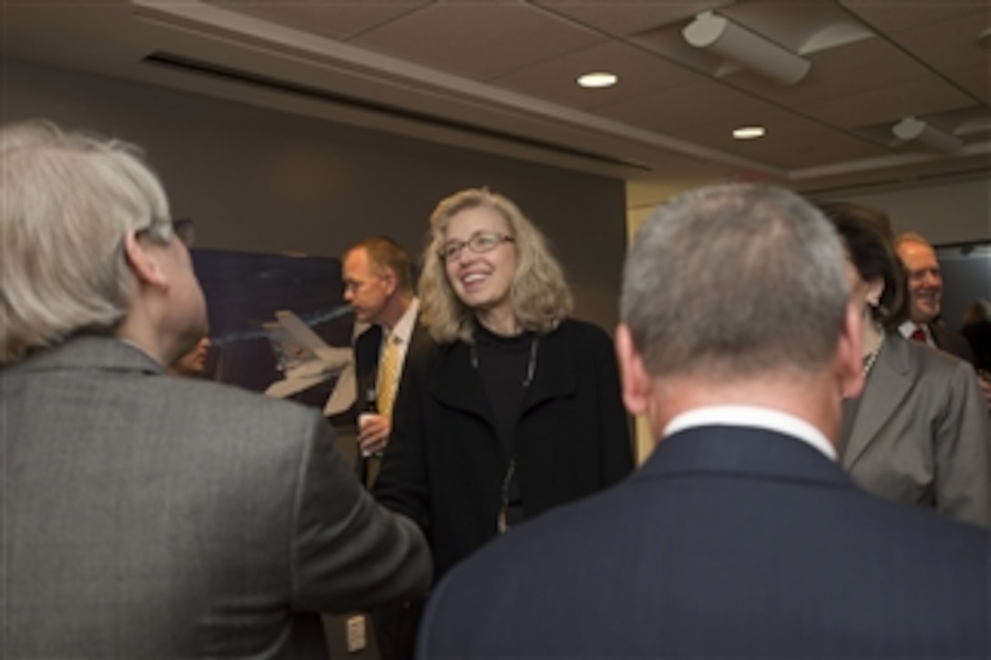 Acting Deputy Defense Secretary Christine H. Fox greets attendees at a meeting of the Aerospace Industries Association Executive Committee in Arlington, Va., Jan. 15, 2014. 