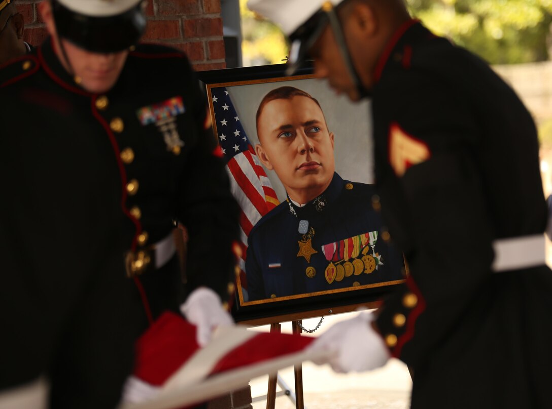 Marines from Marine Corps Recruit Depot Parris Island’s burial team fold the nation’s flag at the funeral of Medal of Honor recipient John James McGinty III, on Jan. 23, 2014, at Beaufort National Cemetery in Beaufort, S.C. McGinty, a decorated Vietnam War hero and Parris Island veteran, died Jan. 17, 2014, in his home in Beaufort at the age of 73.