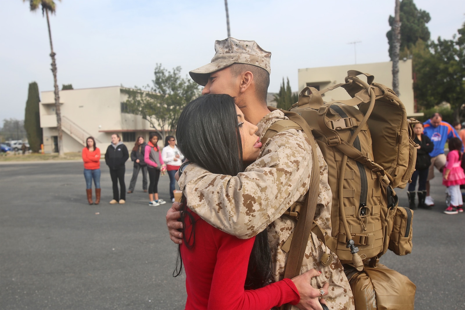 First Lt. Ricky Mansyur, a supply officer with Combat Logistics Battalion 7, Combat Logistics Regiment 1, 1st Marine Logistics Group, hugs his wife, Megan, before boarding a bus as part of his first step of traveling to Camp Leatherneck, Afghanistan, from Camp Pendleton, Calif., Jan. 10, 2014 Marines with CLB-7, along with elements of 1st Explosive Ordnance Disposal Company, 1st Medical Battalion, 1st Dental Battalion and 7th Engineer Support Battalion, will support I Marine Expeditionary Force (Fwd) in assuming responsibilities as the logistics battalion for Regional Command (Southwest). Mansyur is a native of New Jersey, N.J.