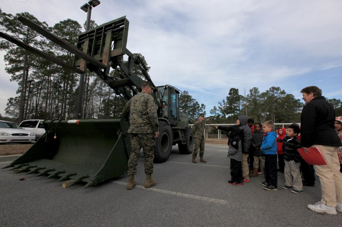 Cpl. Lawrence Hulst (left), a native of Jacksonville, Fla., and Lance Cpl. Joshua Bladdick (right), a native of St. James, Mo., both heavy equipment operators with Marine Wing Support Squadron 273, participate in career day at Michael C. Riley Elementary School in Bluffton, S.C., Jan. 23. The Marines explained and demonstrated the capabilities of their heavy equipment used to support various operations both in deployed environments and at home. Some responsibilites of MWSS-273 include internal airfield communications, weather services, expeditionary airfield services, aircraft rescue and firefighting, aircraft and ground refueling, essential engineering services, motor transport, messing, chemical defense, security and law enforcement, airbase commandant functions, and explosive ordinance disposal. 