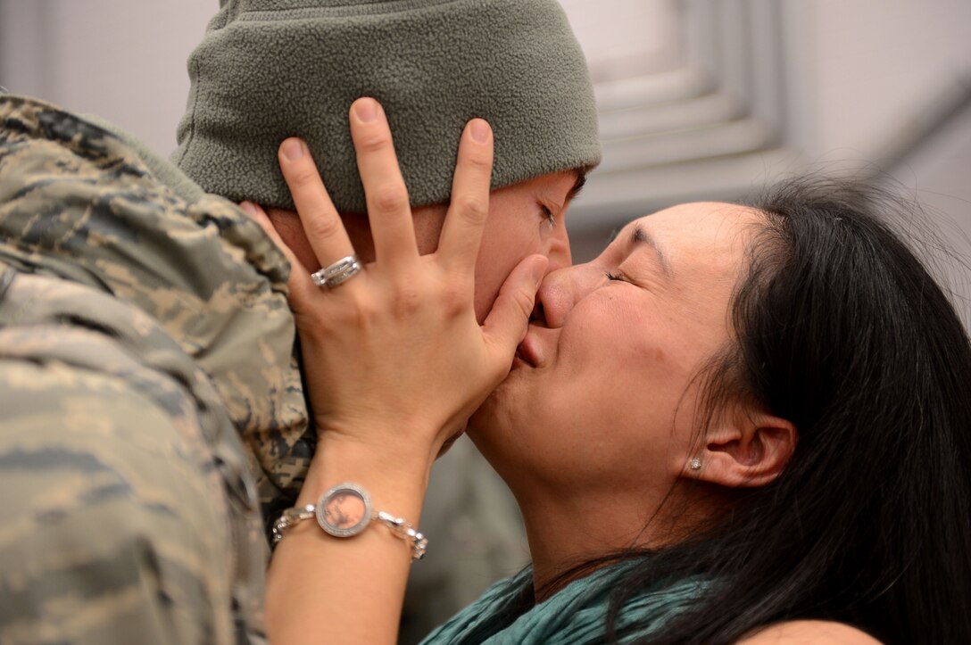 Capt. Joe Faraone reunites with his wife, Suk, Jan. 15, 2014, at Spangdahlem Air Base, Germany, The Airman returned from a deployment to Southwest Asia in support of Operation Enduring Freedom. Faraone serves with the 606th Air Control Squadron. (U.S. Air Force photo/Airman 1st Class Kyle Gese)                