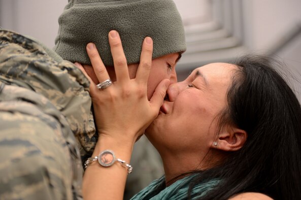 Capt. Joe Faraone reunites with his wife, Suk, Jan. 15, 2014, at Spangdahlem Air Base, Germany, The Airman returned from a deployment to Southwest Asia in support of Operation Enduring Freedom. Faraone serves with the 606th Air Control Squadron. (U.S. Air Force photo/Airman 1st Class Kyle Gese)