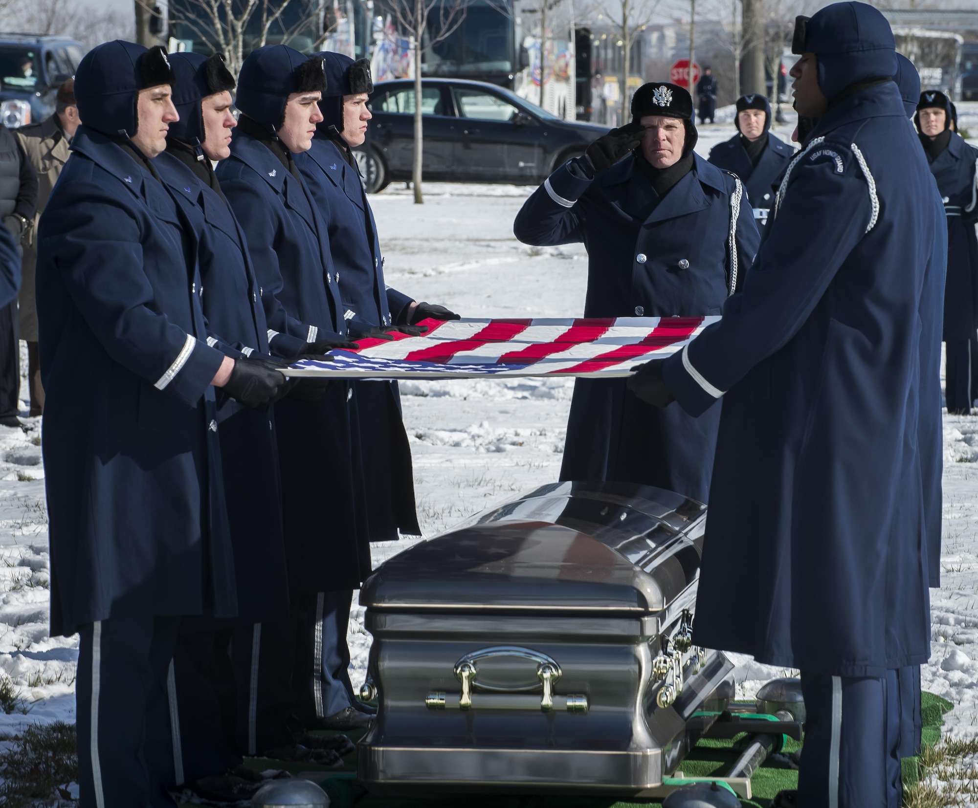 Pall Bearers from the U.S. Air Force Honor Guard fold the flag which draped the the casket of Brig. Gen. Robinson "Robbie" Risner during his internment ceremony at Arlington National Cemetery, Arlington, Va., Jan. 23, 2014. Risner was the Air Force's 20th Ace and and survived  seven and a half years of captivity as a Prisoner of War (POW) in Hoa Lo Prison, a.k.a the Hanoi Hilton. during the Vietnam War. (U.S. Air Force photo/Jim Varhegyi)                                                                                                                                                                                                                                                                                                        