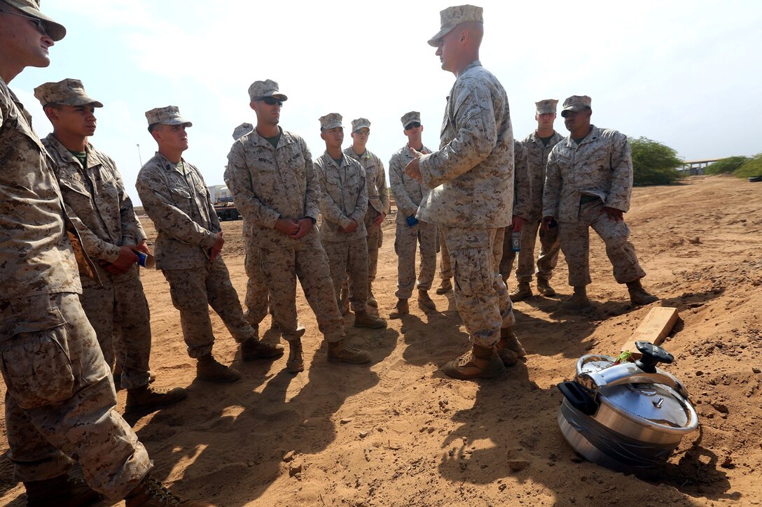 CAMP LEMONNIER, DJIBOUTI (Jan. 10, 2014)  – U.S. Marine Corps Gunnery Sgt. Patrick Hilty, staff noncommissioned officer-in-charge of Explosive Ordnance Disposal Detachment, 13th Marine Expeditionary Unit, discusses the properties of an improvised explosive device (IED) made from a pressure cooker during counter IED training at Camp Lemonnier, Djibouti Jan. 10, 2014. Approximately 50 Marines assigned to Charlie Company, 13th MEU completed counter IED training, which covered a wide variety of techniques to defeat enemy IEDs. The 13th MEU is deployed with the Boxer Amphibious Ready Group as a theater reserve and crisis response force throughout the U.S. 5th Fleet area of responsibility.  (U.S. Marine Corps photo by Staff Sgt. Matt Orr/Released)