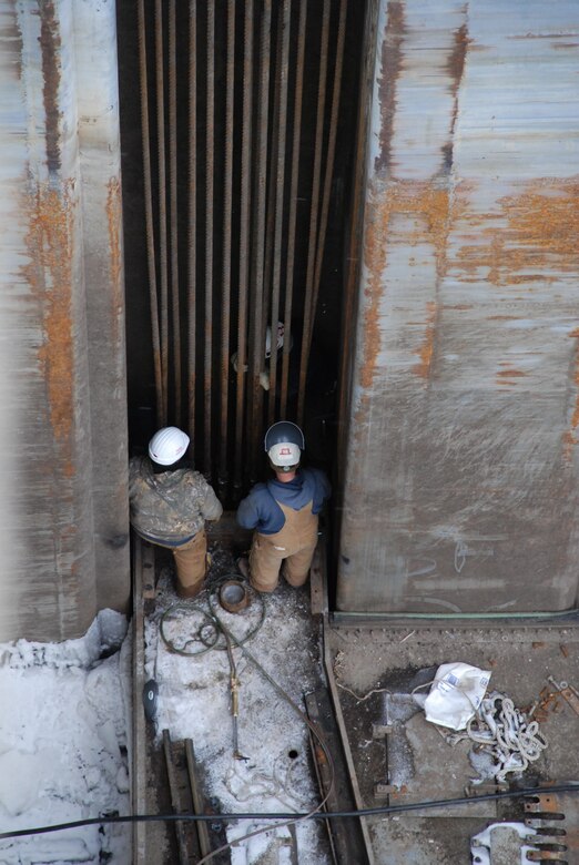 A team from the U.S. Army Corps of Engineers St. Louis District inspects cables in the main lock chamber of Mel Price Locks and Dam in Alton, Ill., Wednesday. The main lock chamber is closed while the Corps investigates and addresses a series of lift gate cable failures. River traffic is still moving through the auxiliary lock. (U.S. Army photo by Mike W. Petersen)