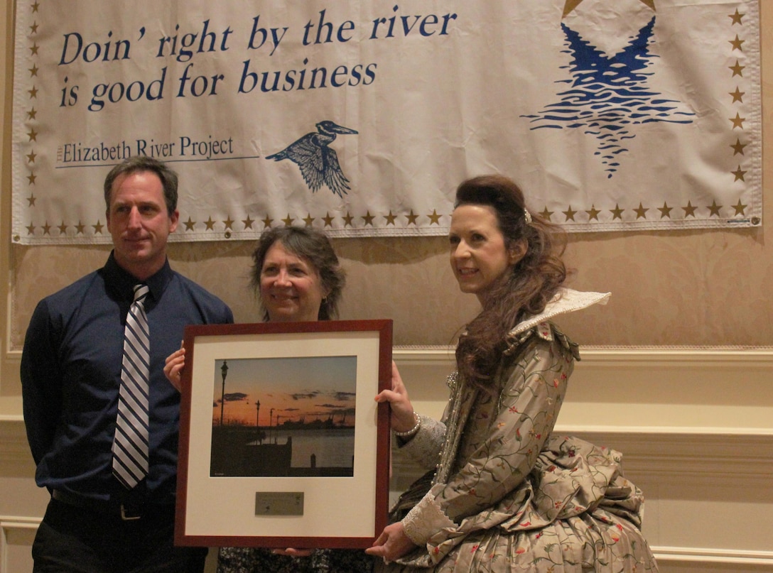 VIRGINIA BEACH, Va. -- Princess Elizabeth presents a plaque to Karin Dridge (right) and Jeff Swallow, geologists from the Norfolk District, at the annual River Stars ceremony here Jan. 23. The district was one of 109 local businesses recognized by the environmental organization for contributions in reducing pollution in the Elizabeth River by 311 million pounds since the Elizabeth River Project began in 1997. The district partnered with a local school and organizations to build a 623-square-foot sanctuary oyster reef in the Elizabeth River – a tidal estuary off the shoreline of historic Fort Norfolk, Va.