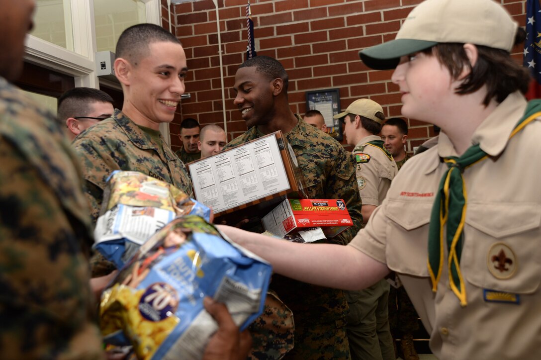 Boy Scouts of America Troop 23, chartered by the Southwest Georgia Homeschool Association, presents more than $8,000 worth of popcorn on behalf of more than 5,000 Boy Scouts in the South Georgia Council to service members at Marine Corps Logistics Base Albany, Jan. 23. The Boy Scouts have an annual popcorn fundraiser, which includes giving patrons an option to donate their purchases to service members.