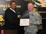 Huntsville Center commander Col. Robert Ruch presents Jefferey Murrell, Installation Support and Programs Management, with a Certificate of Appreciation for deploying in support of Overseas Contingency Operations.