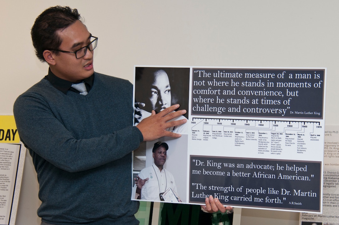Joseph Aguila, district Equal Employment Opportunity Specialist, presents A.R. Smith with a photo collage in thanks for speaking at the Dr. King commemorative event Jan. 22.