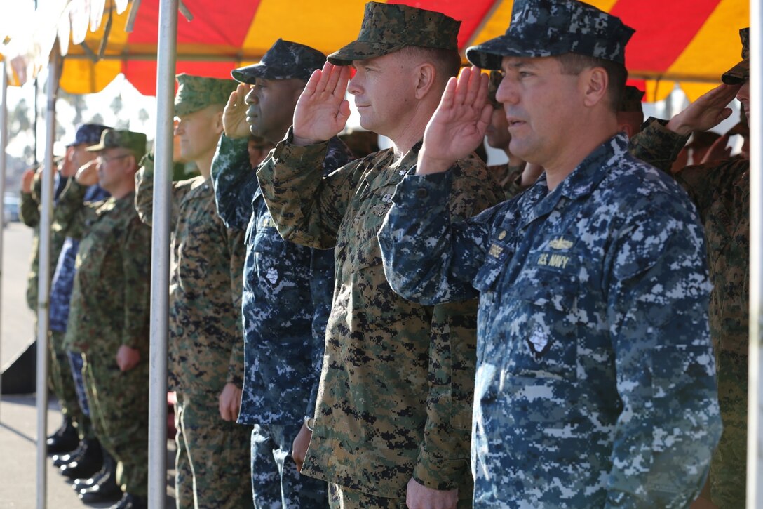 U.S. Marines and sailors and Japanese soldiers render salutes during the American and Japanese national anthems at the opening ceremony of Exercise Iron Fist 2014 aboard Camp Pendleton, Calif., Jan. 23, 2014. Iron Fist is an amphibious exercise that brings together Marines and sailors from the 15th Marine Expeditionary Unit, other I Marine Expeditionary Force units, and soldiers from the Japan Ground Self-Defense Force, to promote military interoperability and hone individual and small-unit skills through challenging, complex and realistic training. (U.S. Marine Corps photo by Lance Cpl. Ricardo Hurtado/Released)