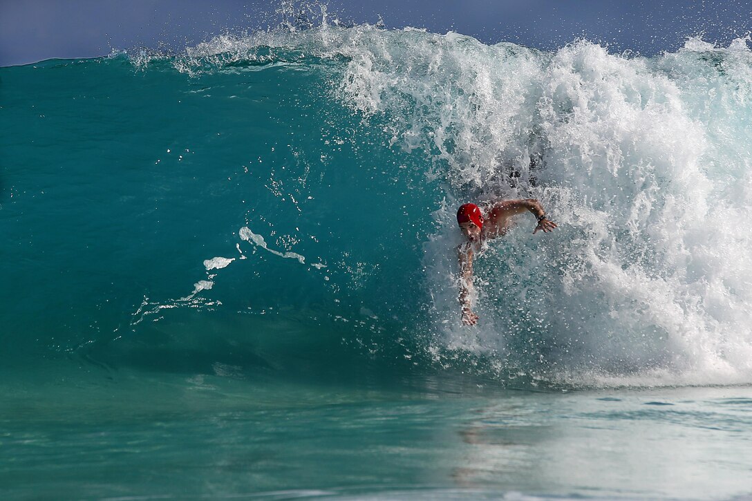 Jeremy Haldeman, a ground radio repairman for Maintenance Company, Combat Logistics Battalion 451, 4th Marine Logistics Group, competes in the 8th annual Pyramid Rock Bodysurfing Championship, Jan. 18, 2014. The event was open to both military personnel and the public, giving everyone the opportunity to find their perfect wave. (U.S. Marine Corps photo by Cpl. Nathan Knapke)