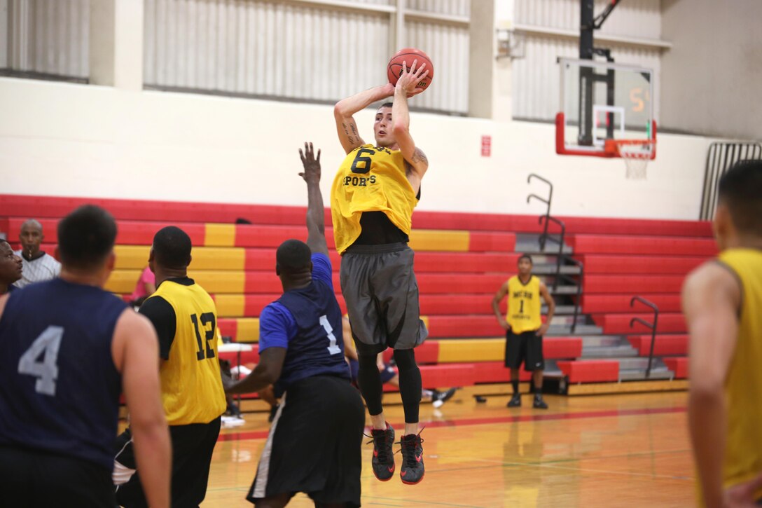Joshua Perry, shooting guard for Marine Aviation Logistics Squadron 24, goes up to shoot the basketball during an intramural basketball game against Marine Corps Air Station Kaneohe Bay at the Semper Fit Center gym, Jan. 21, 2014. Both teams played hard, but MALS-24 was able to take the victory with a score of 40-22. (U.S. Marine Corps photo by Cpl. Nathan Knapke) 