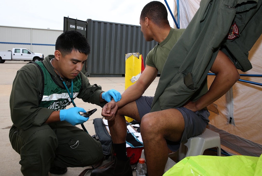 Cpl. Eduardo Cornejo, left, medical surveillance personnel, measures another Marine’s pulse during a practical application portion of a hazardous materials course at the Explosive Ordnance Disposal complex aboard Marine Corps Air Station Miramar, Calif., Jan. 24. The 80-hour course allows the Marines a chance to take different roles in dealing with hazardous materials so they may understand the intricacies of each job.