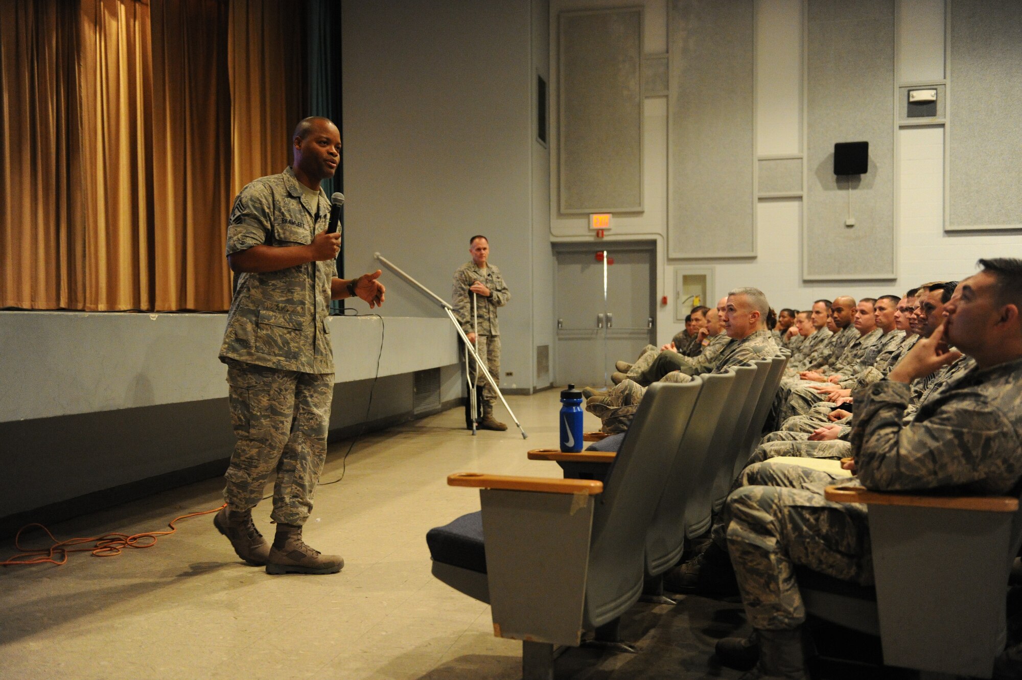 Chief Master Sgt. Les Bramlett, 15th Wing command chief, addresses Airmen during an commander's call at the base theater at Joint Base Pearl Harbor-Hickam, Hawaii, Jan. 23, 2014. During the call, Bramlett thanked the Wing team members for their teamwork and a job well done. (U.S. Air Force photo/Master Sgt. Jerome S. Tayborn)