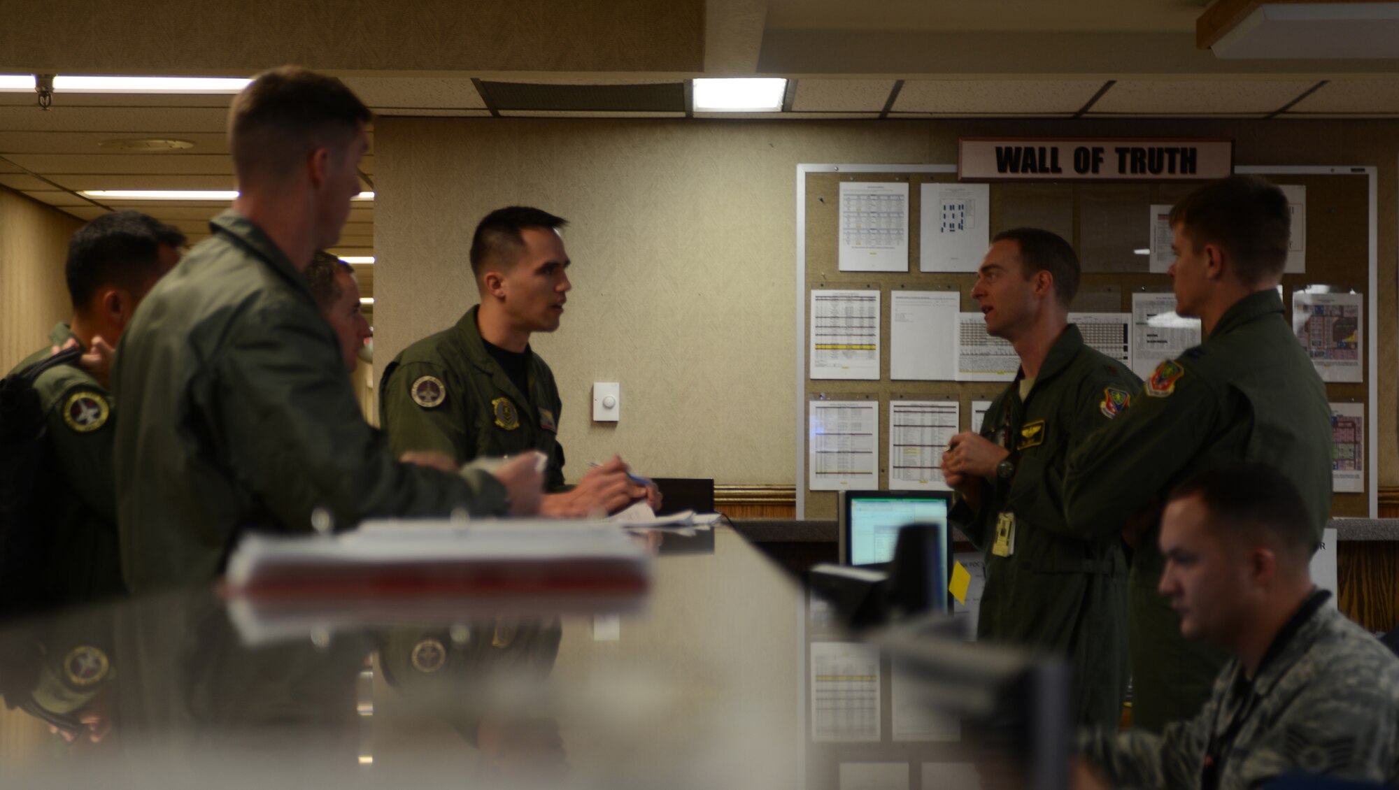 Maj. Bill Lulay, 366th Fighter Wing command post chief, speaks with aircrew personnel before their sortie Jan. 24, 2013, at Nellis Air Force Base, Aircrew from across the globe have converged at Nellis AFB to participate in the combat exercise Red Flag 14-1. (U.S. Air Force photo by Senior Airman Benjamin Sutton/Released)