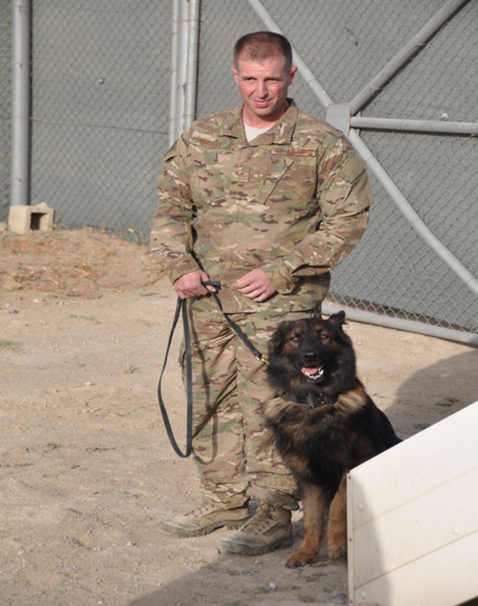 Tech. Sgt. Rafael Rhodes, 7th Security Forces Squadron military working dog trainer, was awarded the Purple Heart and Air Force Combat Action Medals Jan. 24, 2014, for being wounded in action against an enemy of the United States and for directly engaging an enemy while his life was at risk of grave danger while deployed in Afghanistan. Rhodes and his military working dog Nero both sustained injuries from an improvised explosive device explosion, while returning from a 12 hour outside-the-wire mission. (Courtesy Photo)