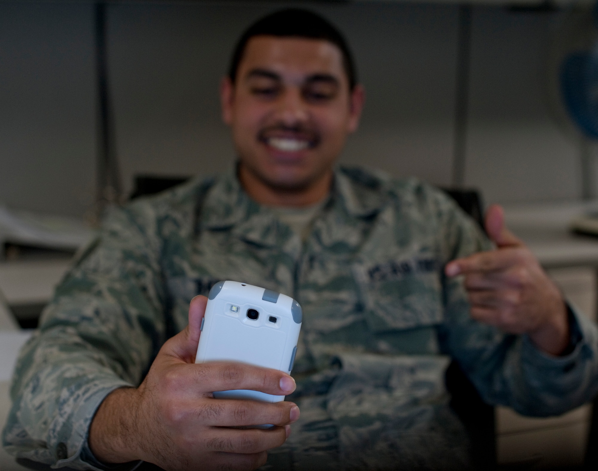 “The new regs on phone covers are great. I can finally have a case that matches my personality. #lol#heeeeyyy,” said Senior Airman Romeh Badr, 366th Comptroller Squadron budget analysis.  The revision to Air Force Instruction 36-2903 paragraph 6.3.3. states, “Handheld electronic devices, if worn on the belt/waistband, or clipped to a purse will be plain black, silver, dark blue, or gray. Handheld electronic devices that are not worn on the belt/waistband/or clipped to a purse can be any color.” (U.S. Air Force photo by Airman 1st Class Brittany A. Chase/Released)