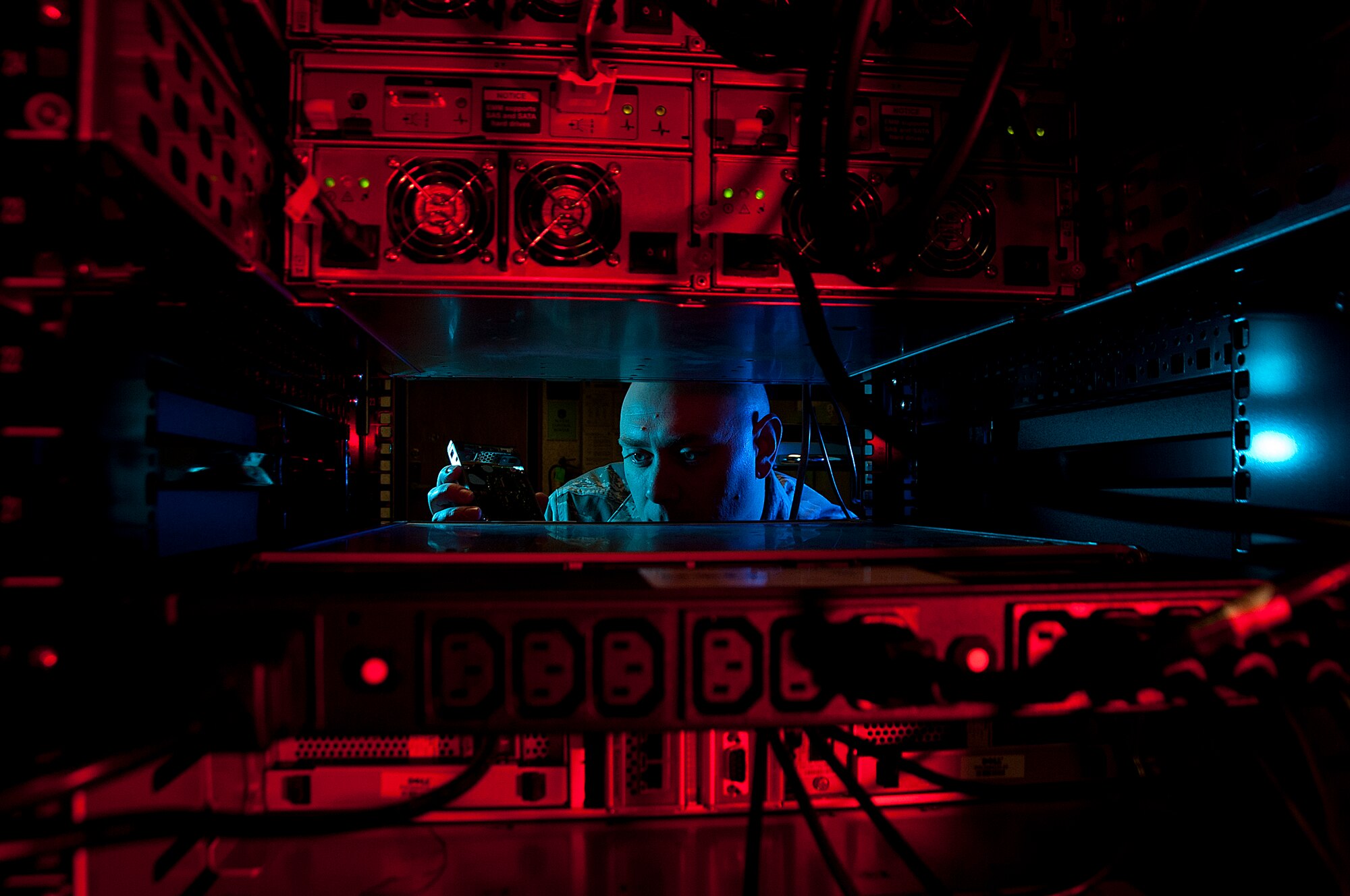 ALTUS AIR FORCE BASE, Okla. – U.S. Air Force Staff Sgt. Jerome Duhan, 97th Communications Squadron network administrator, inserts a hard drive into a retina server inside the 97th network control center Jan. 24, 2014. The 97th Air Mobility Wing is scheduled to undergo its first phase three Command Cyber Readiness Inspection during the week of Jan. 27, 2014. Base members can assist by removing their common access cards from the computer the moment they walk away. (U.S. Air Force photo by Senior Airman Franklin R. Ramos/Released) 