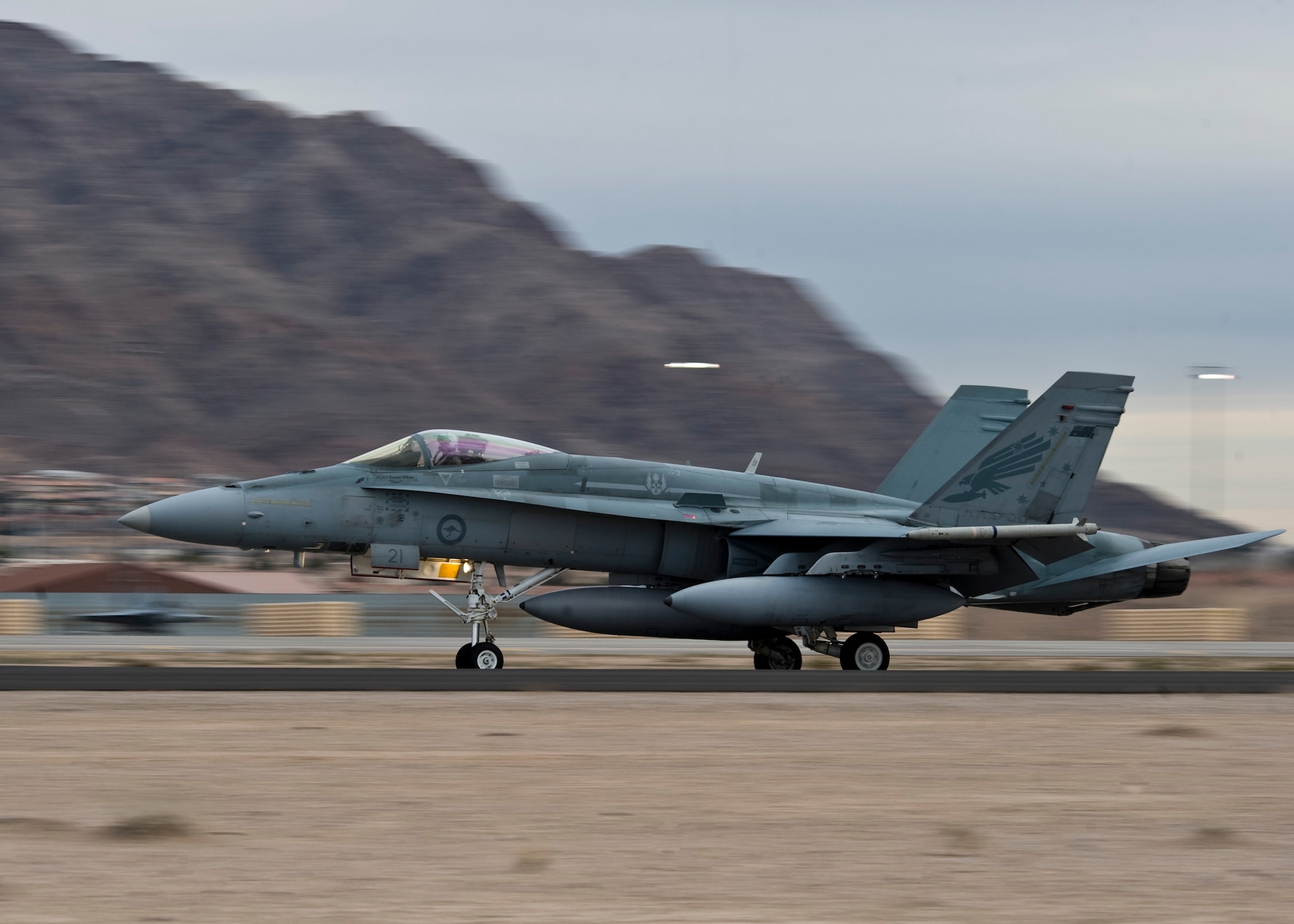 A Royal Australian Air Force 77th Squadron F/A-18 Hornet lands Jan. 23, 2014, at Nellis Air Force Base, Nev. The 77th Squadron was established in 1942 and is located at RAAF Base Williamtown. The RAAF will be participating in Red Flag 14-1 Jan. 27 – Feb. 14. Red Flag is one of a series of advanced training programs administered by the United States Air Force Warfare Center. (U.S. Air Force photo by Airman 1st Class Jason Couillard)  