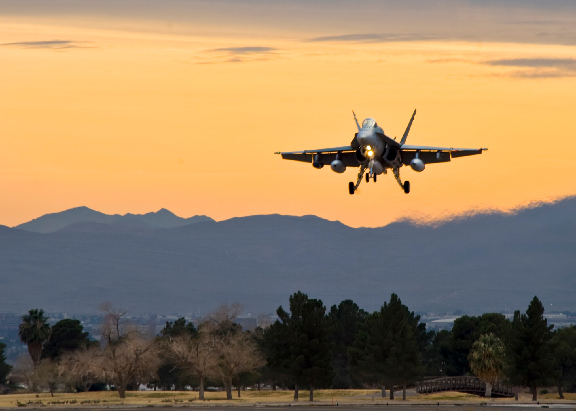 A Royal Australian Air Force 77th Squadron F/A-18 Hornet prepares to land Jan. 23, 2014, at Nellis Air Force Base, Nev. The RAAF is at Nellis to participate in Red Flag 14-1 Jan. 27 to Feb. 14. Red Flag 14-1 is an air-to-air combat training exercise in the skies over the Nevada Test and Training Range. The purpose of the exercise is to increase the combat capability of U.S. and allied air forces for future combat situations. (U.S. Air Force photo by Airman 1st Class Jason Couillard)  