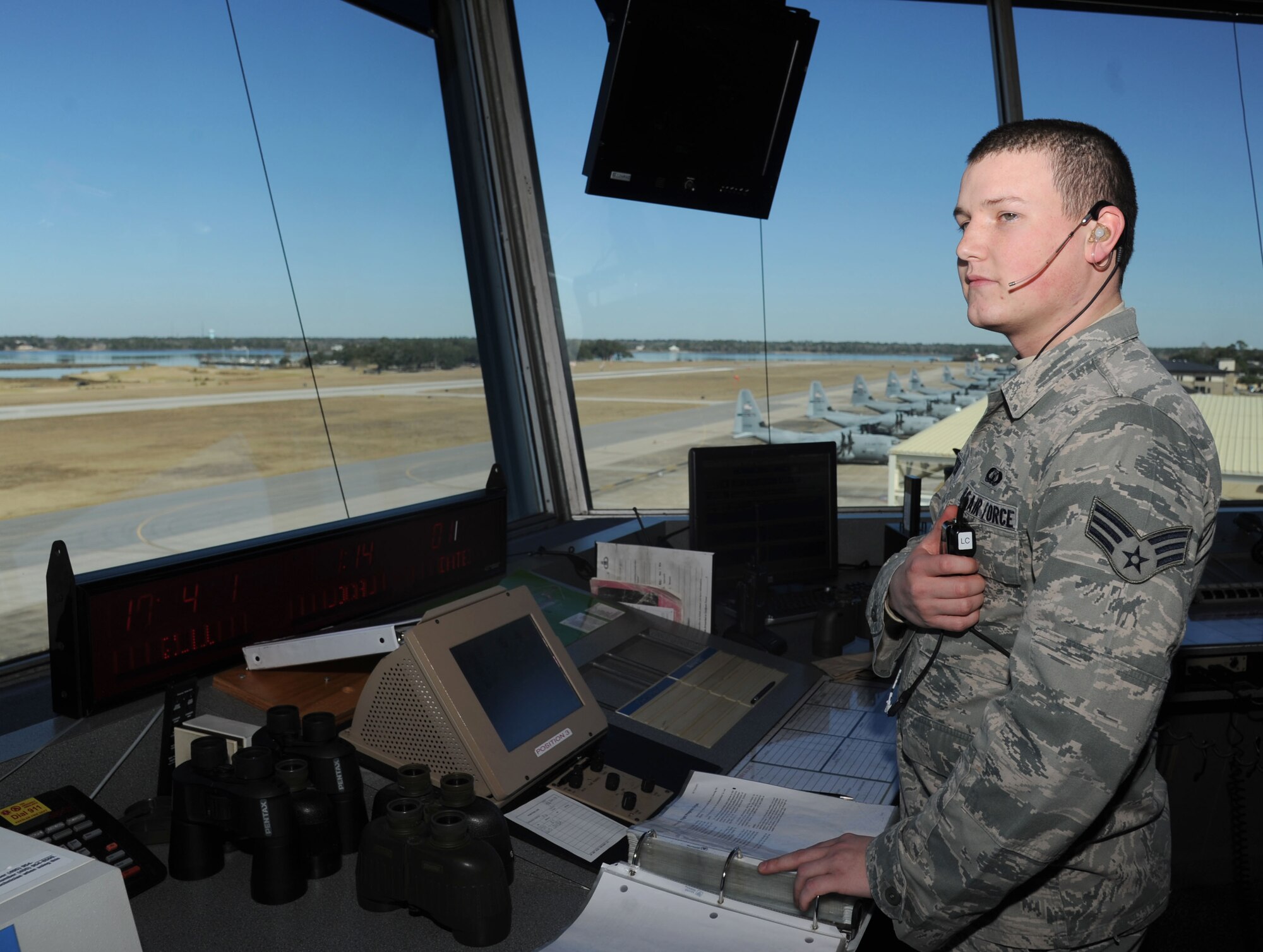 Senior Airman Gavin Hunter, 81st Operations Support Flight air traffic controller, observes the Keesler flight line for approaching aircraft Jan. 22, 2014, inside the Air Traffic Control Tower, Keesler Air Force Base, Miss.  Hunter was one of the first on-scene responders to a vehicle accident Nov. 23, 2013, on highway 67.  (U.S. Air Force photo by Kemberly Groue)